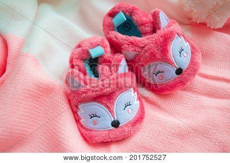 Close up of baby shoes on a wood background. Greeting card