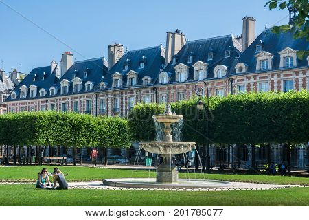 Paris France - August 13 2016: The Place des Vosges originally Place Royale is the oldest planned square in Paris and one of the finest in the city.