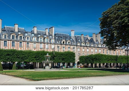 Paris France - August 13 2016: The Place des Vosges originally Place Royale is the oldest planned square in Paris and one of the finest in the city.
