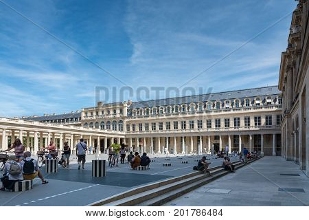Paris France - August 13 2016: Tourists inside the Palais-Royal originally called the Palais-Cardinal is a palace located in the 1st arrondissement of Paris. The screened entrance court faces the Place du Palais-Royal opposite the Louvre.