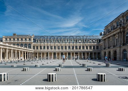 Paris France - August 13 2016: Tourists inside the Palais-Royal originally called the Palais-Cardinal is a palace located in the 1st arrondissement of Paris. The screened entrance court faces the Place du Palais-Royal opposite the Louvre.
