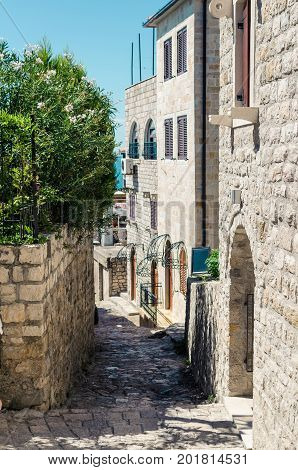 Old narrow street in Stari Grad of Ulcinj Montenegro. The fortress in the Old town in a sunny summer day.