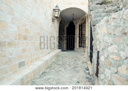 Old narrow street in Stari Grad of Ulcinj Montenegro. The fortress in the Old town in a sunny summer day.