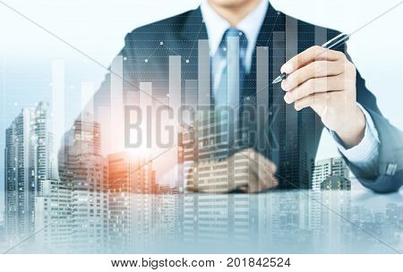 businessman present increasing graph with city background, business growth