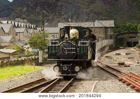 Blaenau Ffestiniog Wales UK - August 22 2017: Narrow gauge Double Fairlie steam locomotive Iarll Meirionnydd of the Ffestiniog Railway Company approaching the station