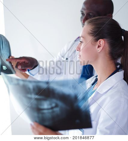 Doctors analyzing an x-ray in a meting. Doctors