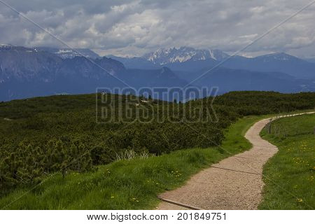 Landscape view of the walking trail near the observation deck on the top of the mountain, in the vicinity of Bolzano, Italy