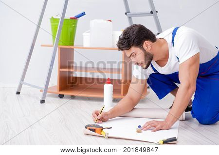 Repairman doing renovation repair in the house with paper wallpa