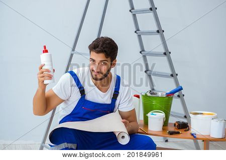 Repairman doing renovation repair in the house with paper wallpa