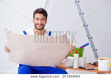 Repairman doing renovation repair in the house with paper wallpa