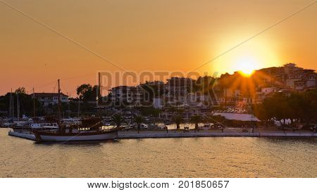 Ships in a harbor of Neos Marmaros at sunset in Sithonia, Greece