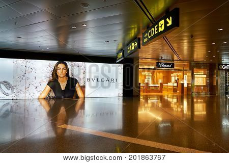 DOHA, QATAR - CIRCA MAY, 2017: Bvlgari advertisement and Chopard store at Hamad International Airport of Doha, the capital city of Qatar.