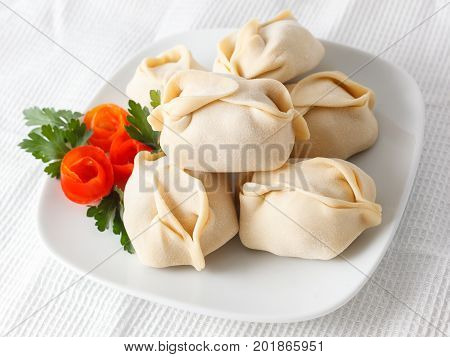 Frozen Dumplings On The White Plate With Green