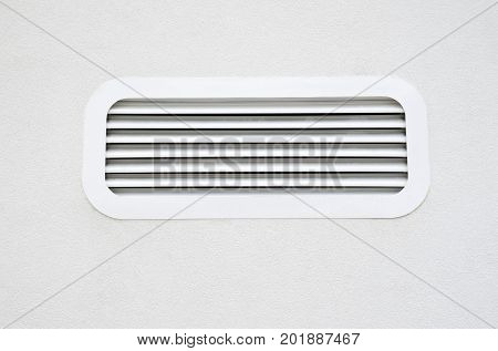 New white air conditioning vent on wall closeup