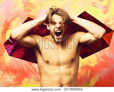 Caucasian Bearded Sexy Macho Man Holding Red Packages Or Bags