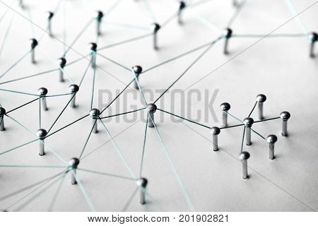 Connected Networks. Networking, social media, SNS, internet communication abstract. Small network connected to a larger net. Web of light to dark blue, wires on white background. Muted tone. 