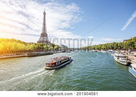 Landscpae view on the Eiffel tower and Seine river with tourist boat in Paris