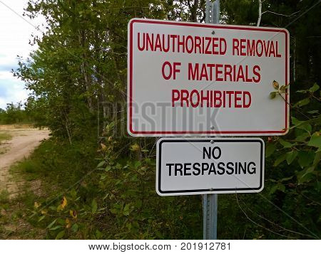 A No UnAuthorized Removal of Materials Sign.