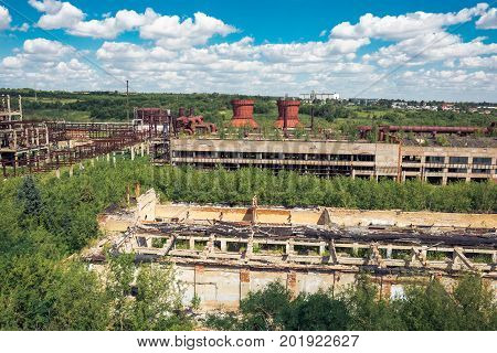 Panoramic aerial view from above to Soviet abandoned factory in Efremov, Russia. Abandoned buildings, workshops overgrown with green forest