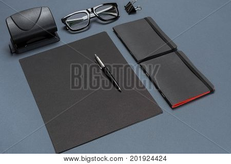 A set of black office accessories, glasses on gray background. Flat lay. Still life. Mock-up