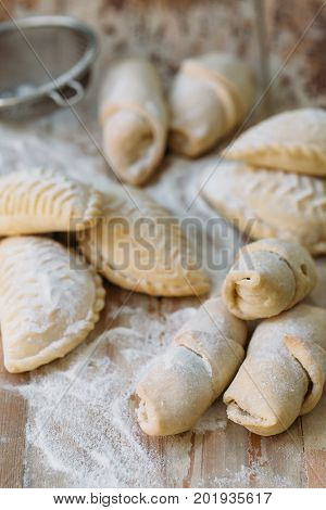 Roll cookies with nuts on a wooden table. Georgian dessert. Croissants, pastry rolls