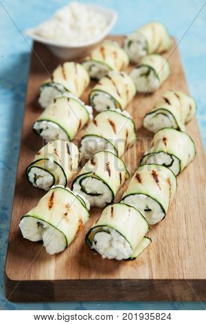 Grilled zucchini rolls filled with fresh cottage cheese