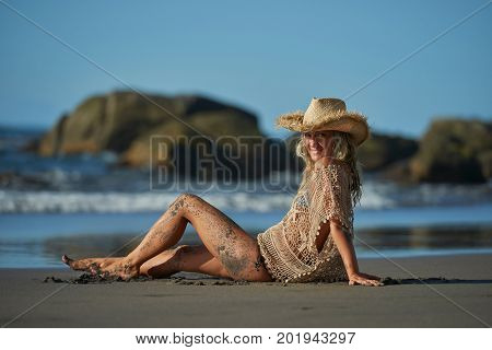 young woman relaxing on the beach in summer day