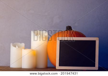 Pumpkin And Candles With Blackboard Menu