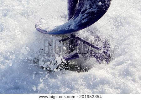 Closeup View Of A Ice Fishing Hole Being Drilled