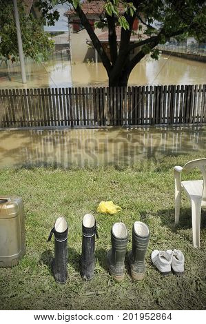Concept photo of flooding. Waterproof rubber boots