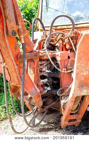 Hydraulic piston system for bulldozers tractors excavators chrome plated cylinder shaft of yellow machine construction heavy industry detail selective focus