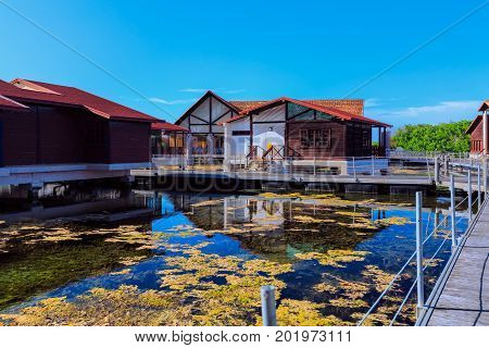 Cayo Coco island, Cuba, Iberostar Mojito resort, July 17, 2017, looks like it's northern country, but it's Cayo Coco island Cuba, hotel grounds with villa houses standing in natural sea water on sunny nice day