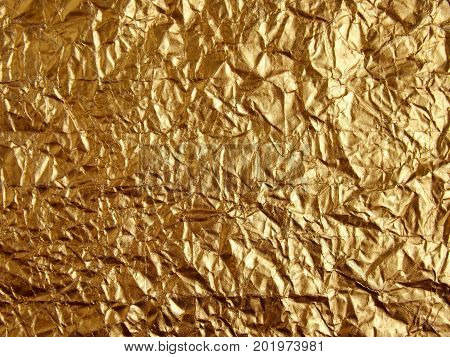 Gold wrinkled paper texture abstract background .