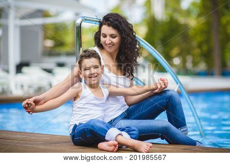 Family On Vacation Having Fun at Outdoor Pool.