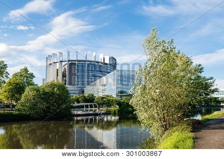 Large Modern Headquarter Of European Parliament In Strasbourg With Boat Stop And Calm Flowing Ill Ri