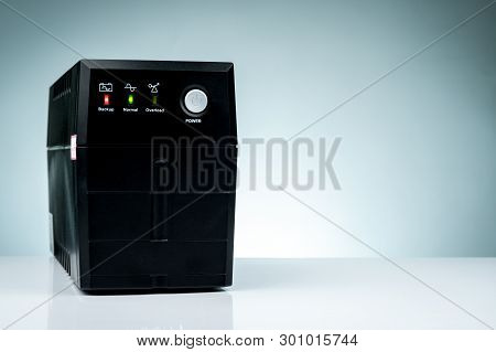Uninterruptible Power Supply. Backup Power Ups With Battery Isolated On Table. Ups For Pc. Equipment