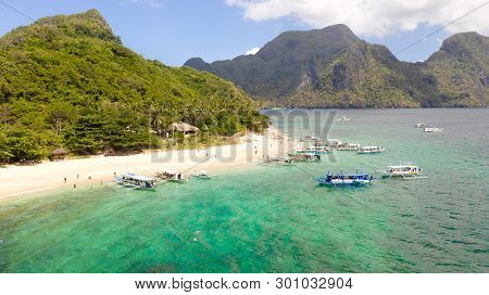 Tourists Relax On The White Beach Of The Island Of Helikopter.tropical White Sand Beach. Seascape Wi
