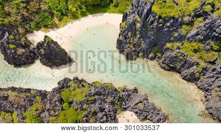 El Nido Palawan National Park Philippines. Warm Hidden Lagoon Near The Rocks. Tourists Relax On The 