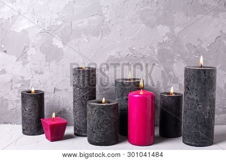 Black And Red  Burning Candles  On Grey Textured Background. Spa Or Still Life Concept. Selective Fo