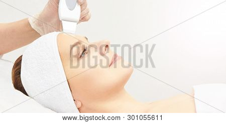 Ultrasinic Cosmetology Face Equipment. Facial Skin Cleaning. Beauty Female Girl. Medical Salon Care