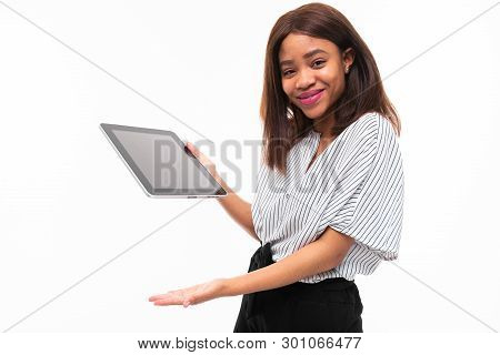 Portrait Of African Young Girl Possing With Grey Tablet In Hands On Background