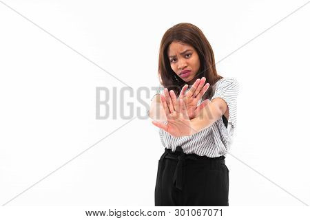 Portrait Of African Young Girl Possing And Gesticulates Hands On Background