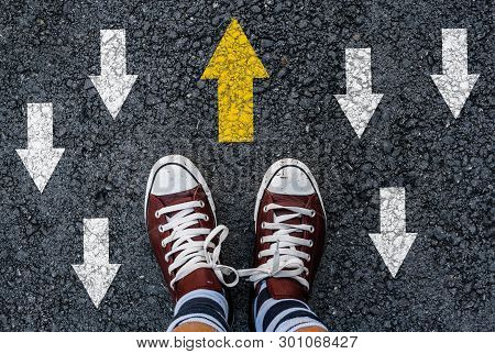 Man Shoes On Asphalt And Opposing Direction Arrows On Asphalt Ground, Personal Perspective Footsie C