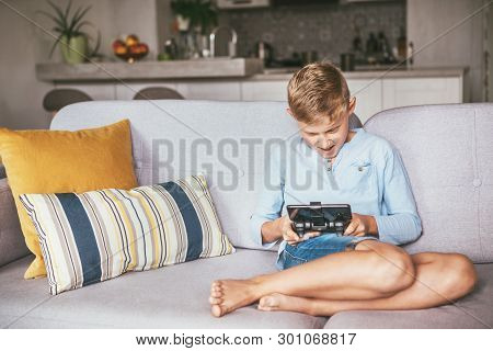 Teenager Boy Emotionaly Plays On The Game Console Connected With Smartphone