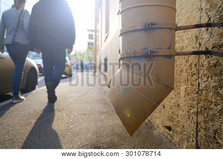 The Silhouette Of Passers-by On A Small City Street. Woman Holding A Man By The Arm, Walking On The 