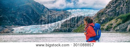 Alaska glacier travel destination Mendenhall tourist attraction in Juneau, USA. Woman walking at ice landscape background panoramic.