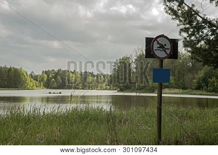 Swimming Prohibited.
Lake, A Large Water Reservoir Amidst Forests. The Shores Overgrown With Tall Gr