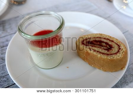 Cake Roll With Panakota On Plate In Restaurant