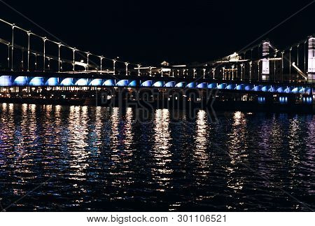 Illuminated Crimean Krymsky Bridge At Night With Water Reflection, Moskva River, Moscow.