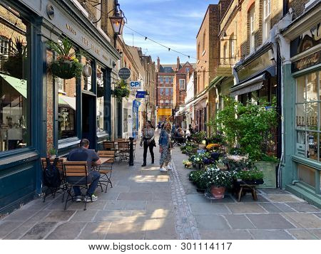 HAMPSTEAD, LONDON - MAY 14, 2019: Tourists visit cafes and business on Flask Walk in Hampstead, North London, UK.